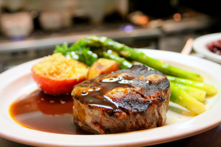 delicious steak, squash, and asparagus on a plate at home