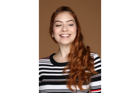 smiling redhead woman with striped sweater