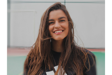 smiling woman with brown hair and black sweater