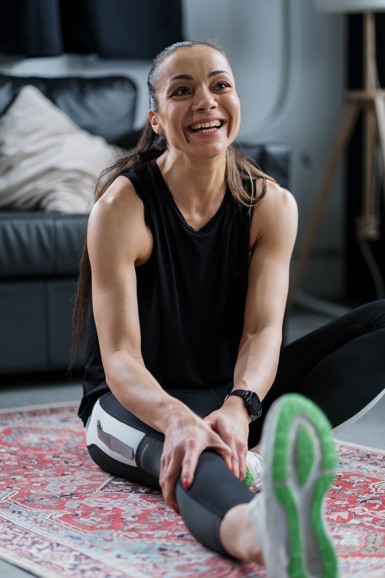 fit happy woman stretching after a great online at home workout